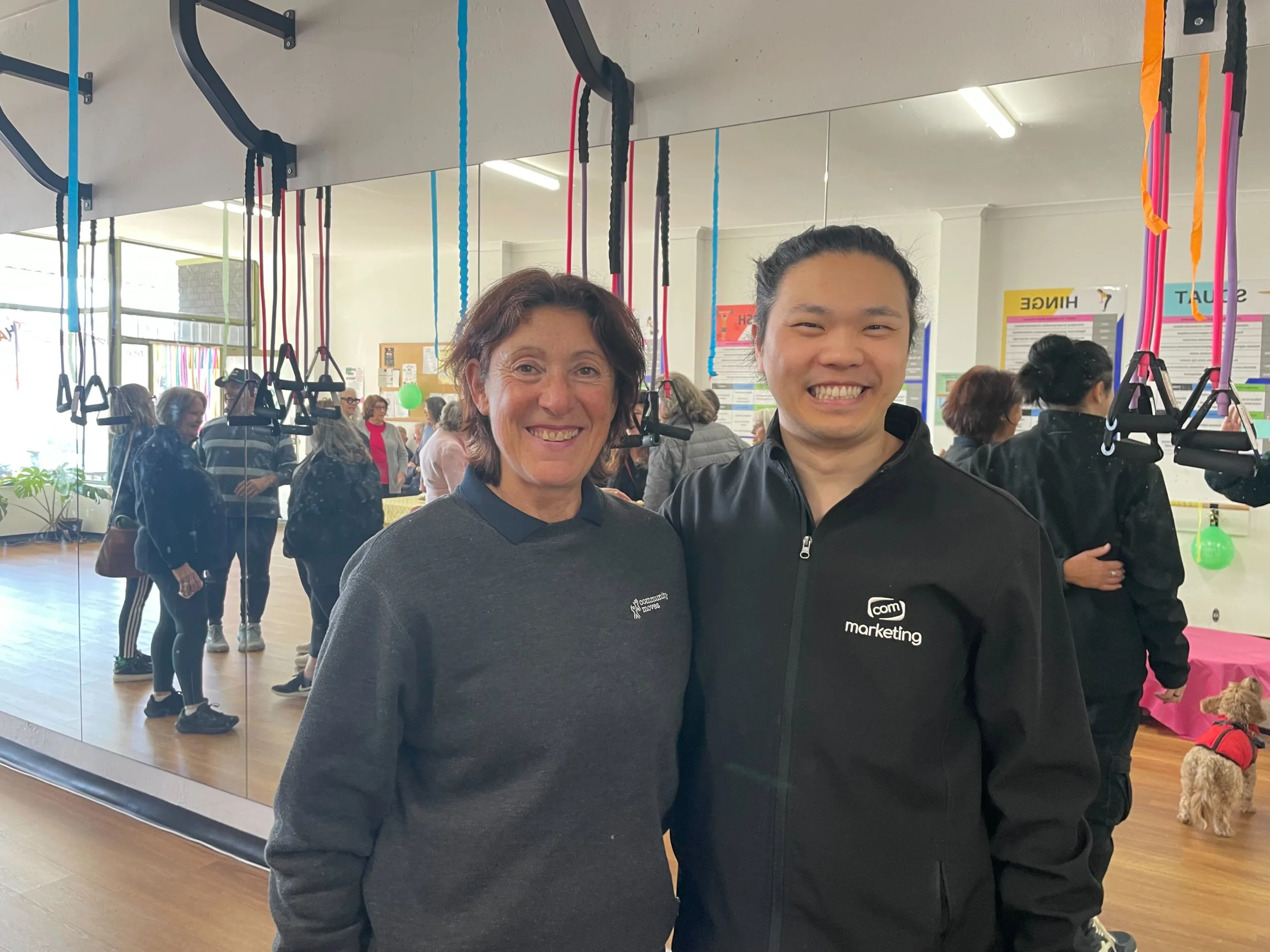 COM Market Leaders owner David Ji posing with staff member of Community Moves